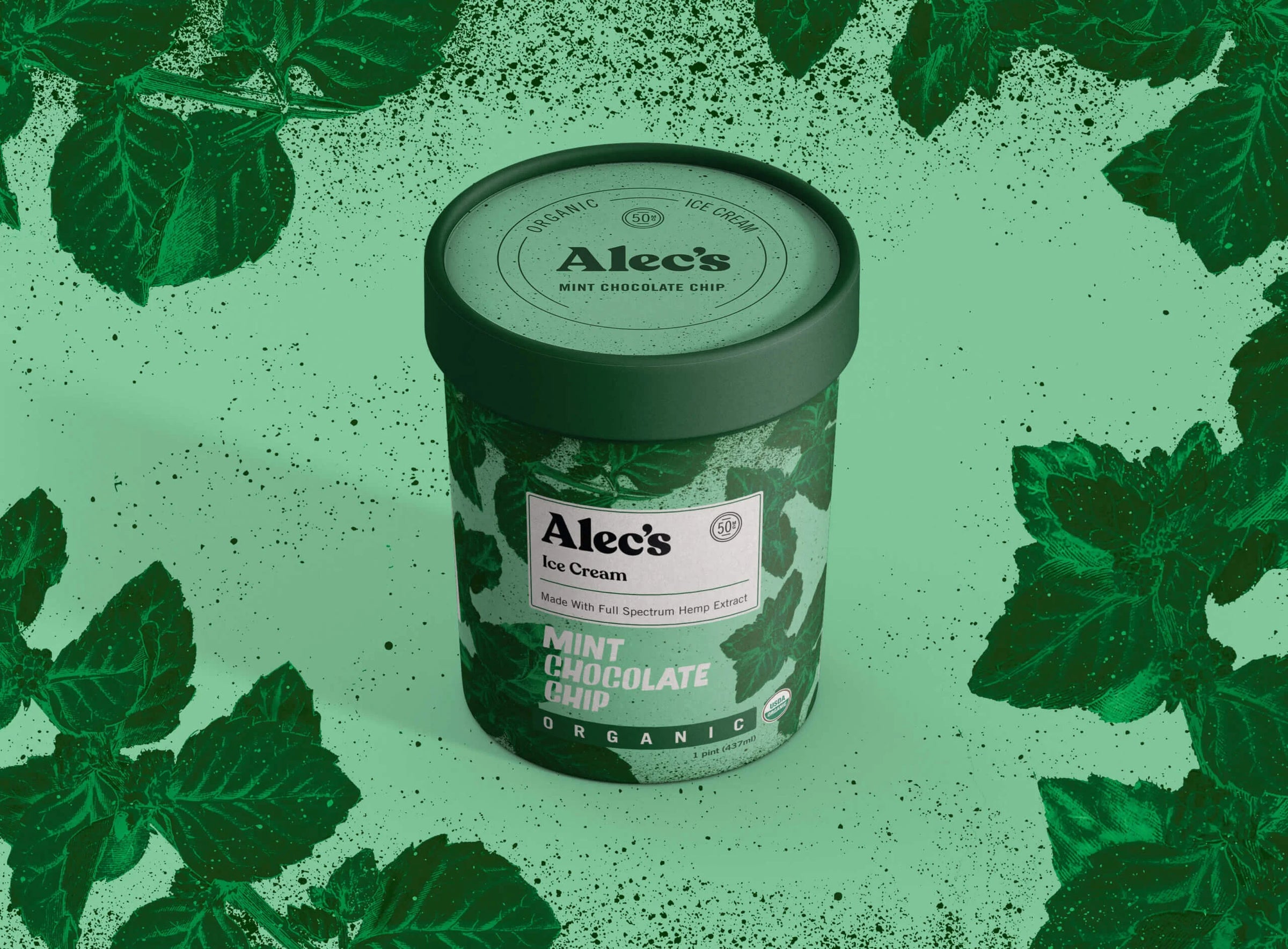 A container of Alec's Mint Chocolate Chip ice cream on a green background with mint leaves.