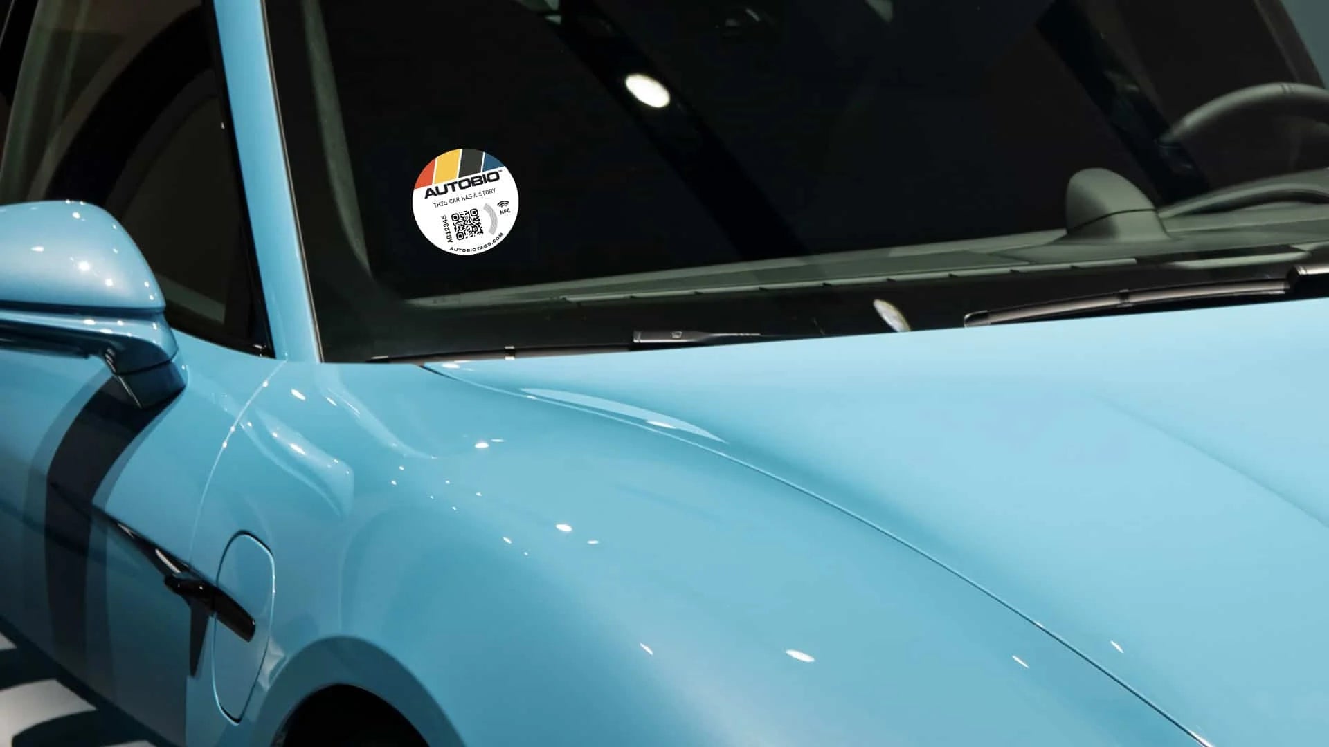 Close-up of a car window with a sticker on a light blue vehicle