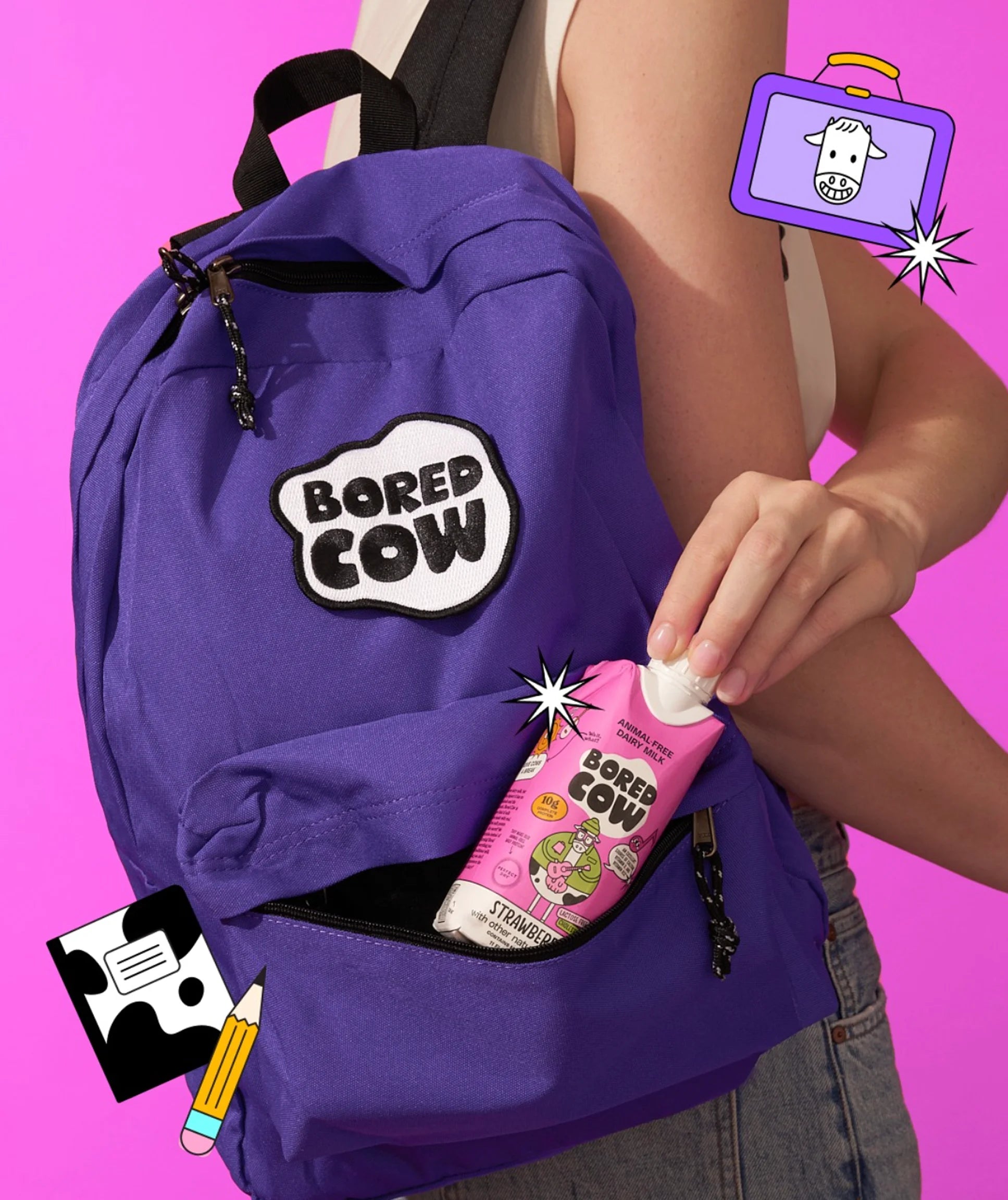 Purple backpack with 'Bored Cow' branding, person opening a pink package labeled 'Bored Cow' against a pink background.