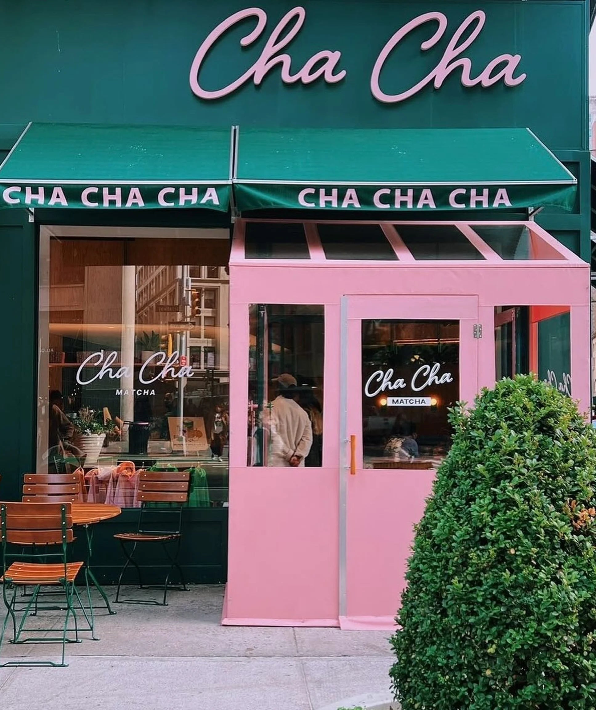 Pink and green 'Cha Cha' restaurant exterior with outdoor seating area.