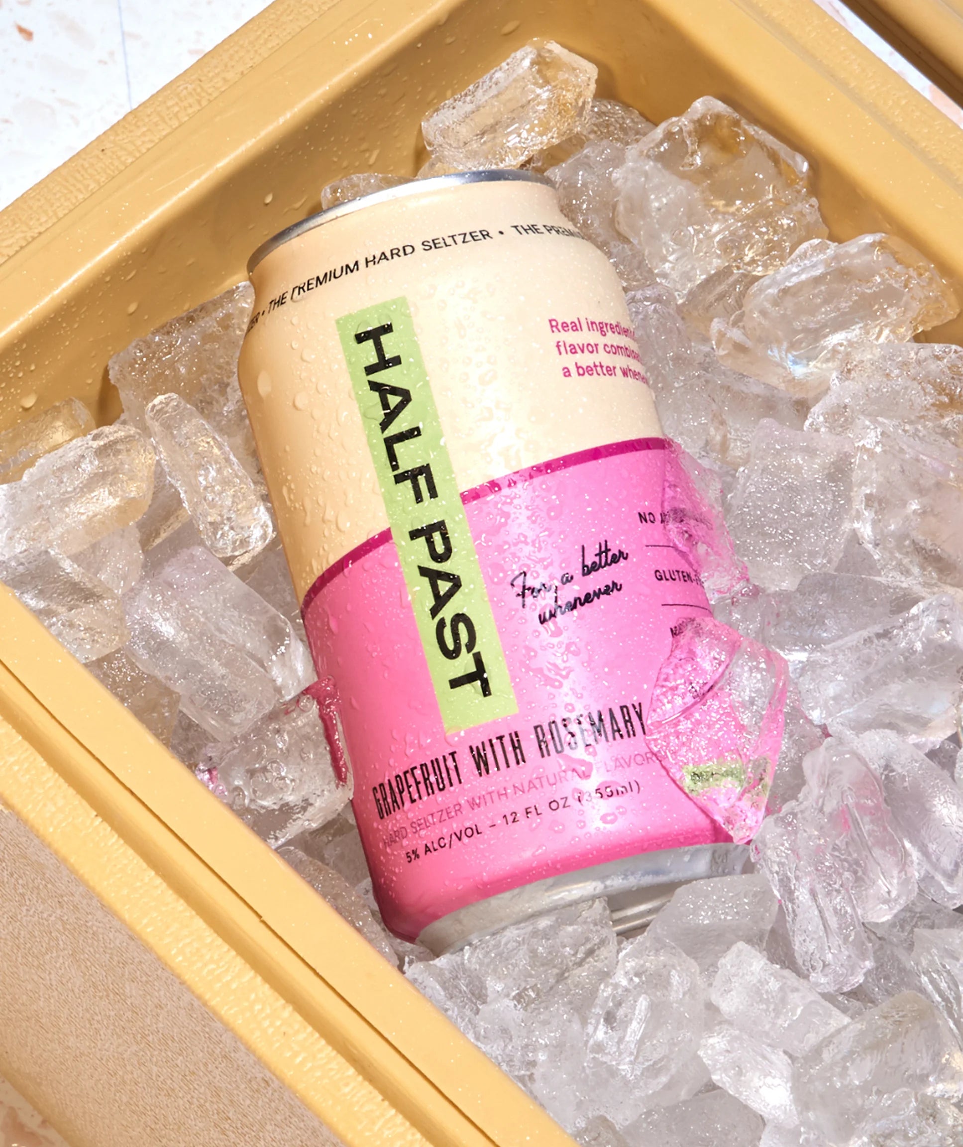 Half Past hard seltzer can in a cooler with ice