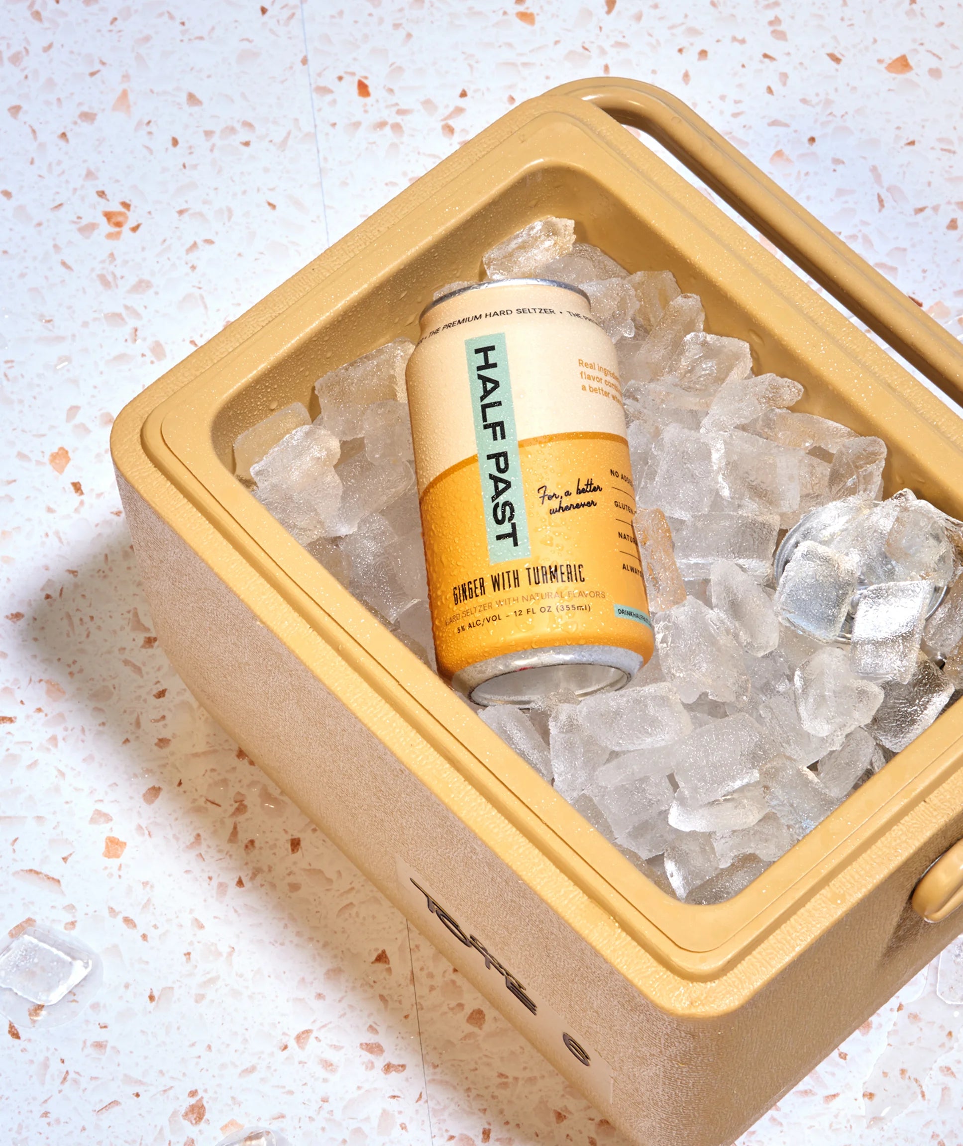 Can of Half Past beer on ice in a yellow cooler