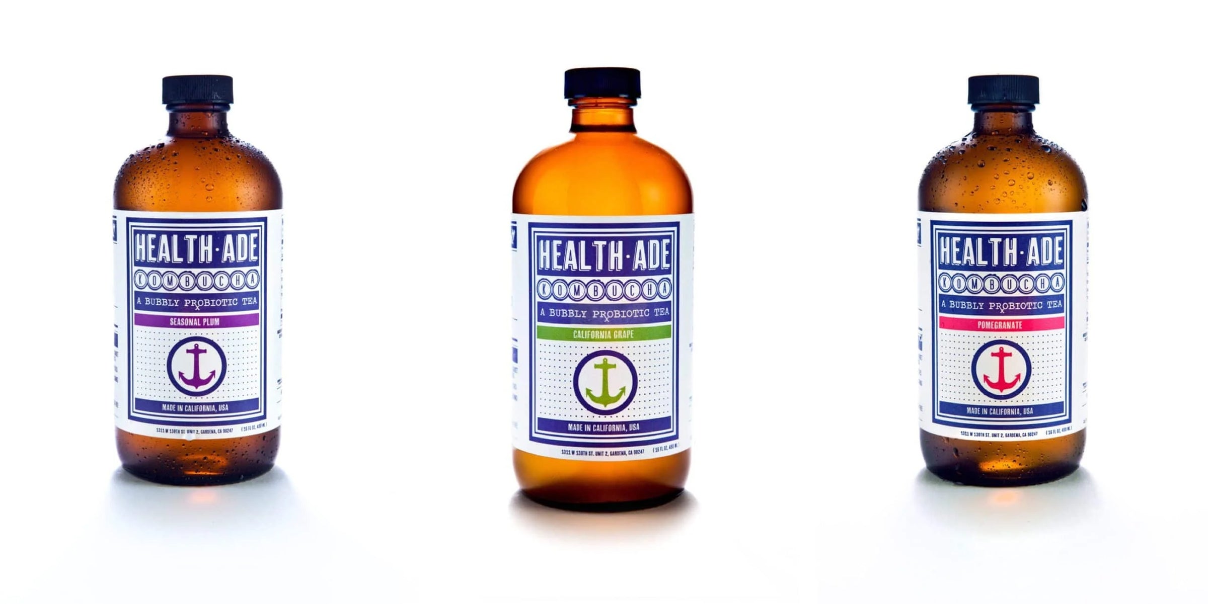 Three Health-Ade bottles with labels on a white background