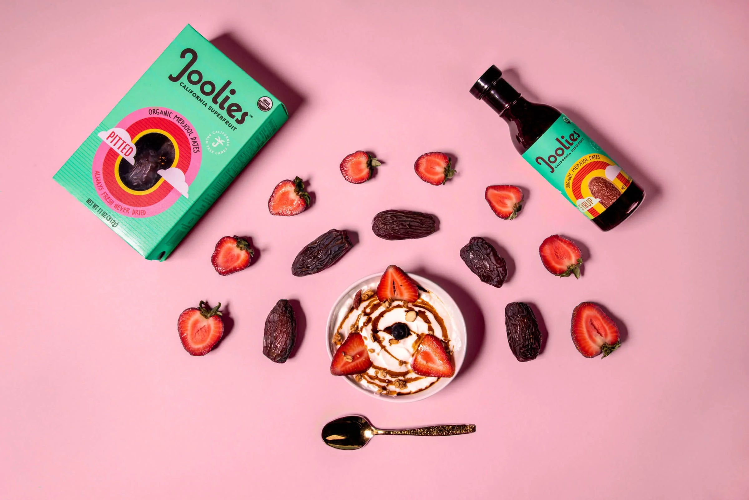 Joolies product packaging and ingredients on a pink background