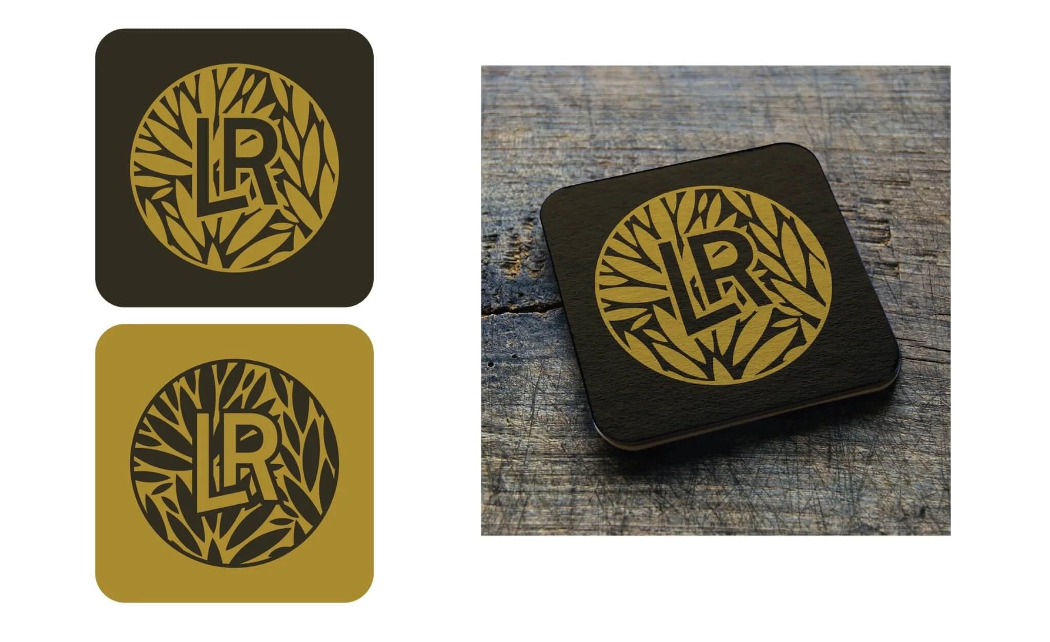 Two coasters with a black and gold design on a wooden surface