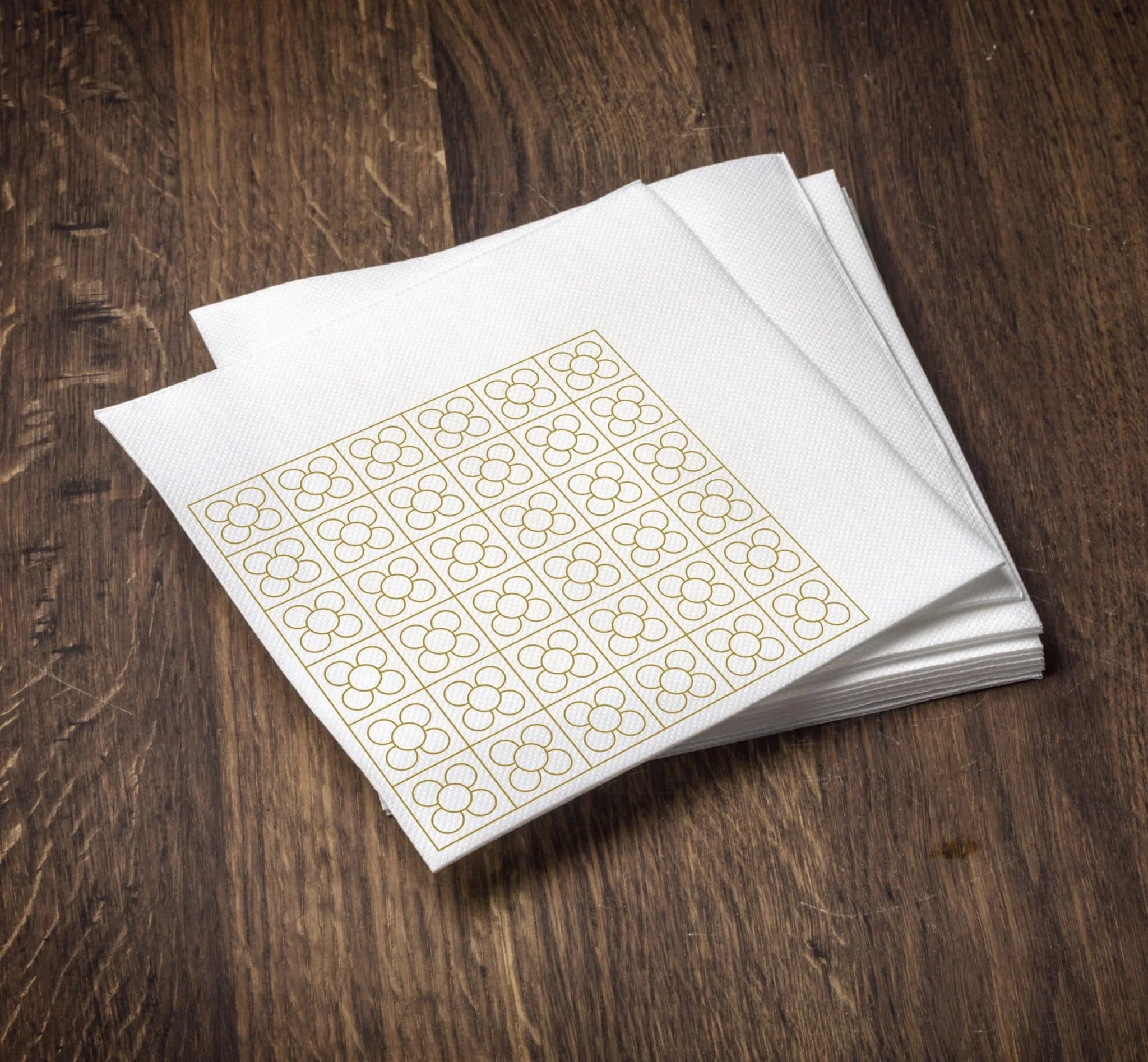 Sheet of gold foil stickers on a wooden surface