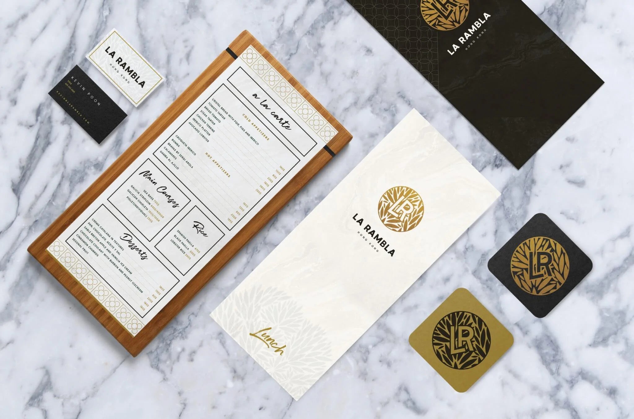 La Mamila branded menu, coasters, and cards on a marble surface