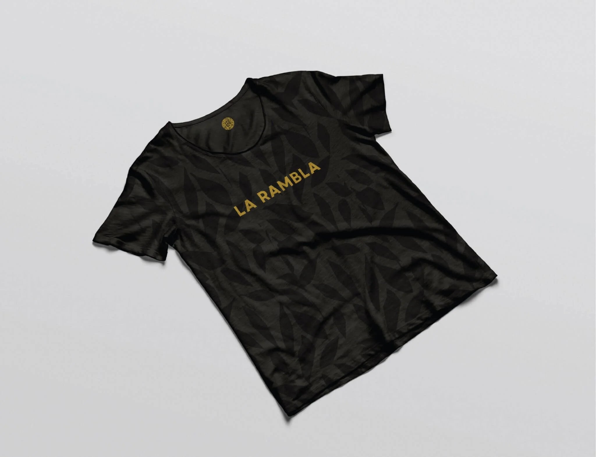 Black t-shirt with 'LA RAMBLA' text on a light gray background