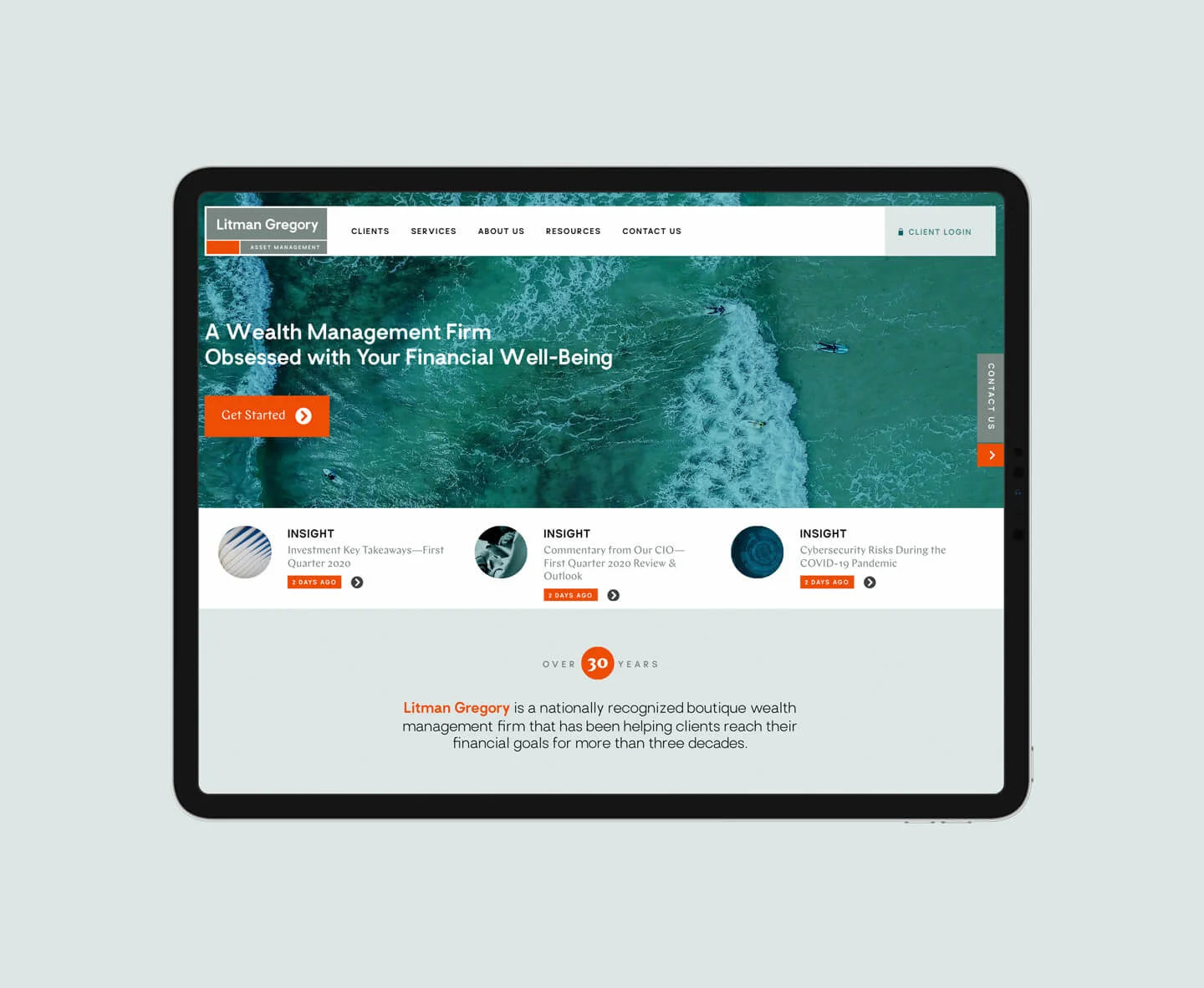 Website homepage displayed on a tablet with a light gray background