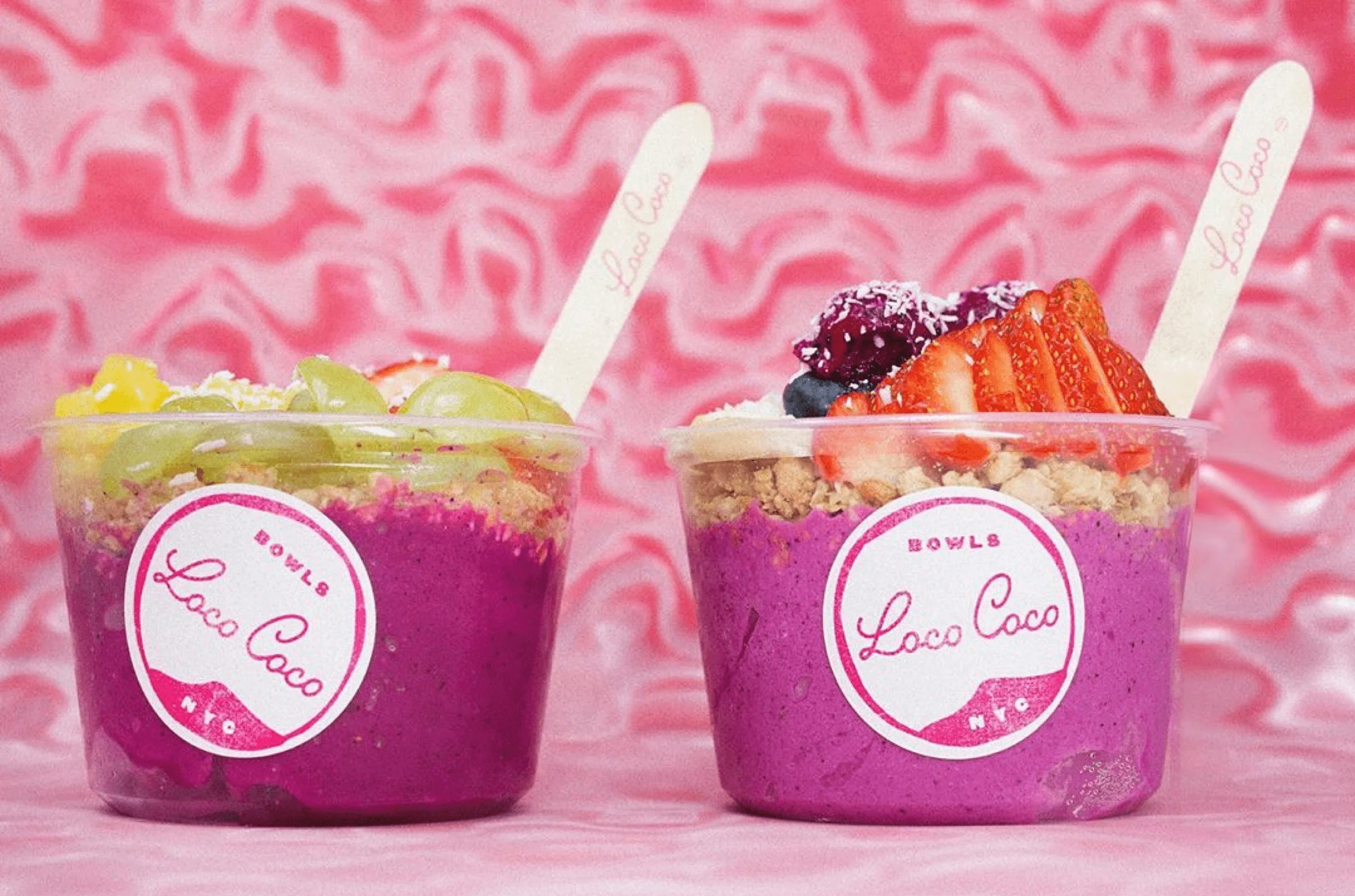 Two pink dessert bowls with colorful toppings on a pink background, featuring the Loco Coco brand.