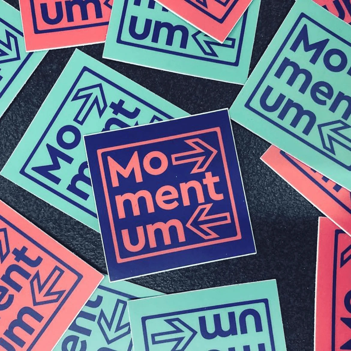 Stickers with 'Momentum' design on a dark background