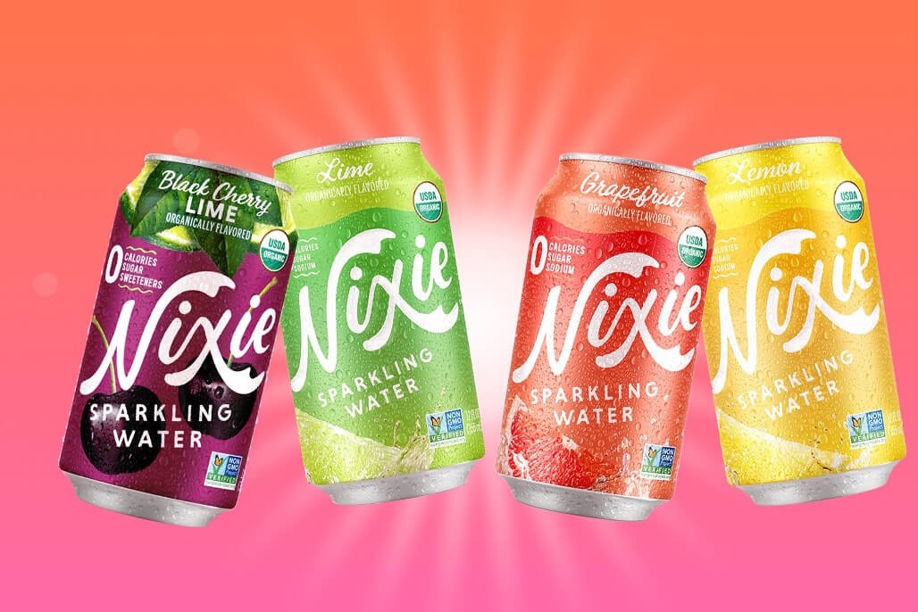 Four cans of Nixie sparkling water with different flavors on a colorful background