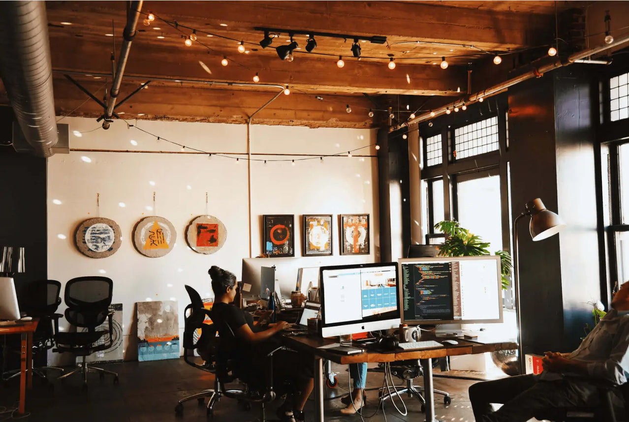 Modern office space with employees working at their desks.