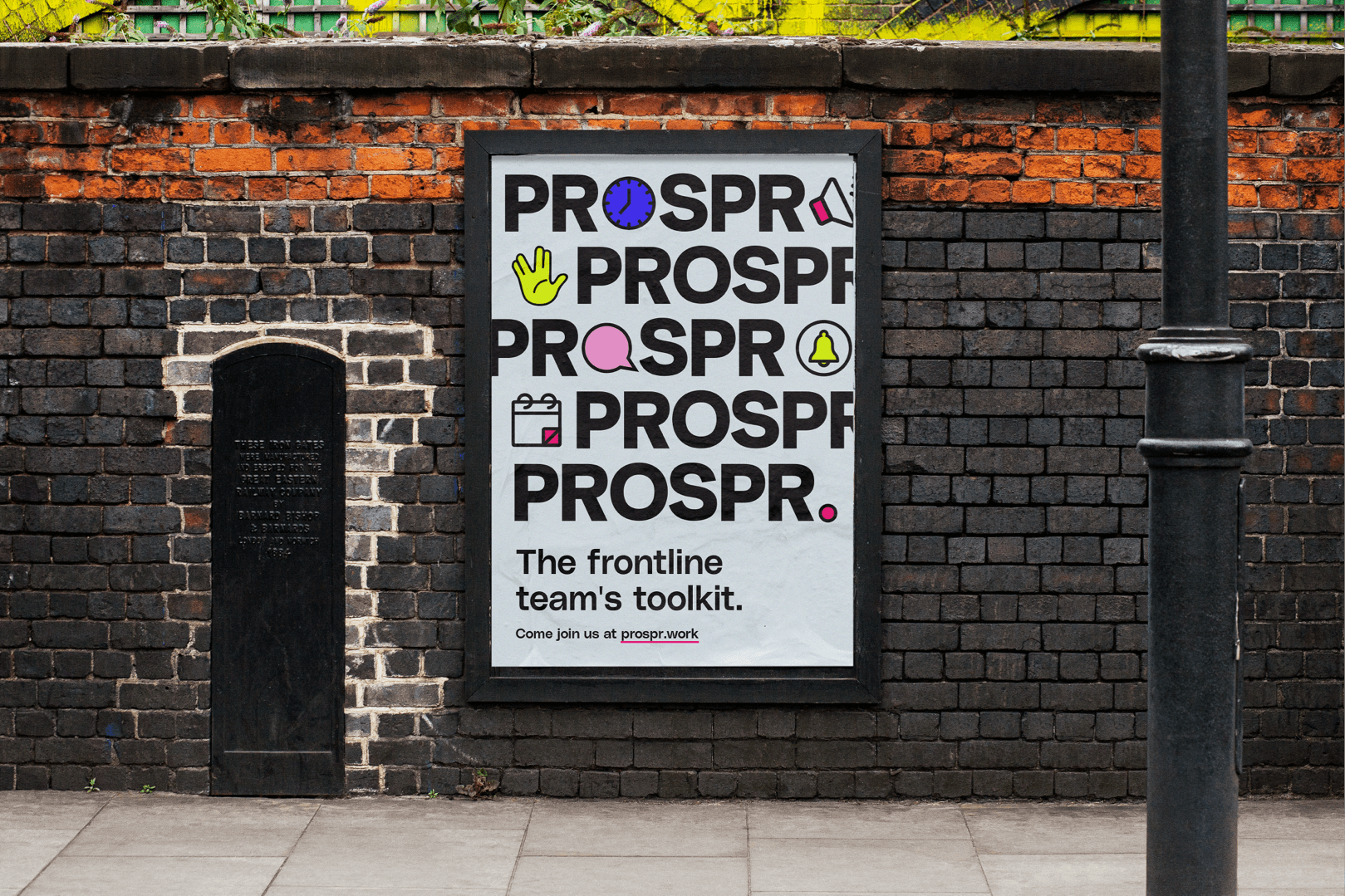 Framed poster with 'PROSPR' branding on a brick wall.