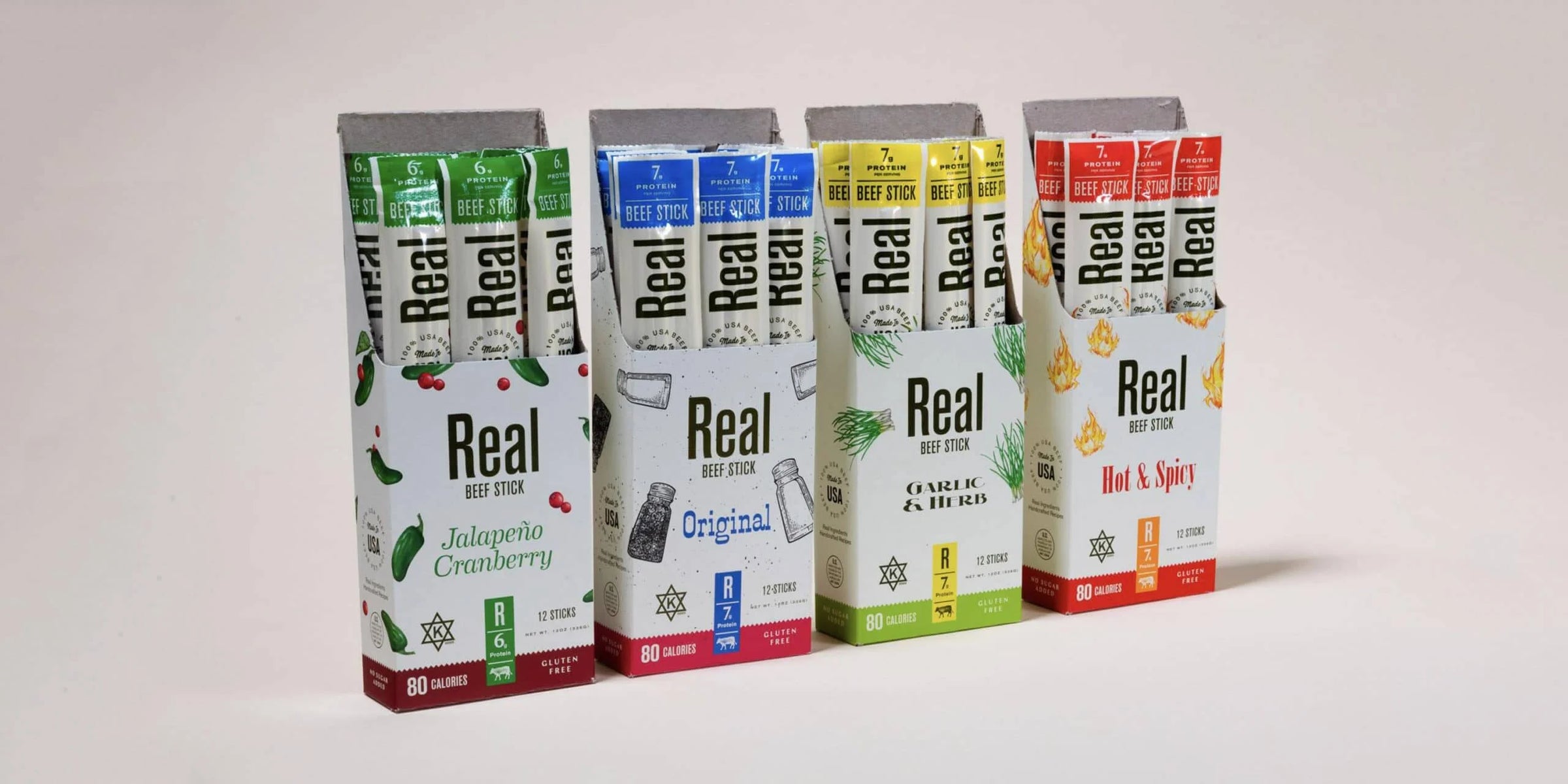 Set of Real Snacks beef sticks on a green and brown gradient background