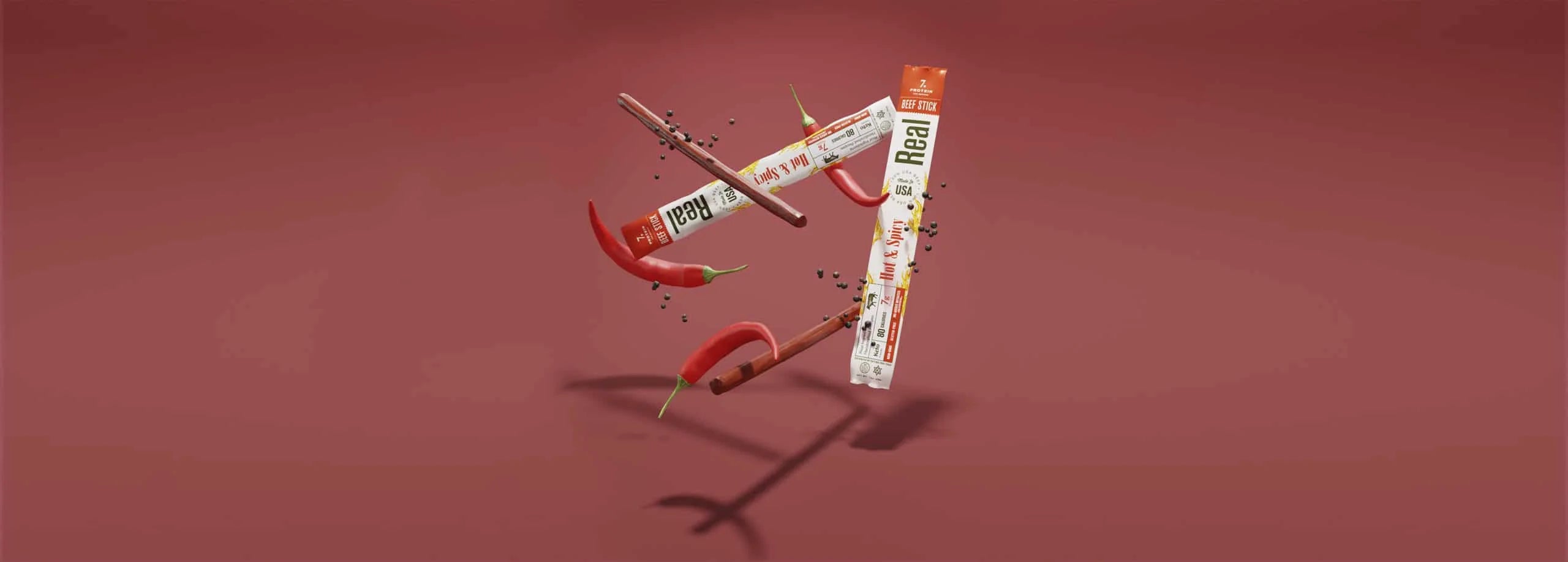 Real Snacks beef sticks with visible branding on a red background