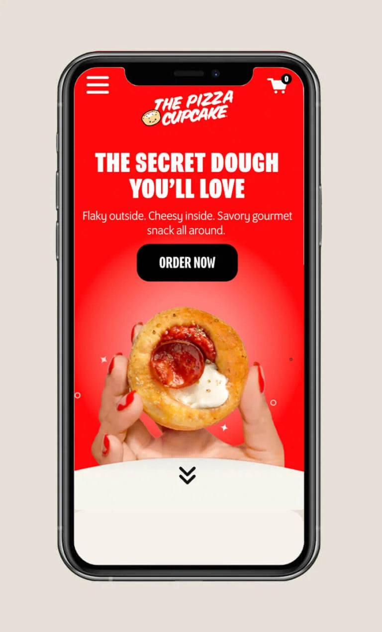 Phone displaying The Pizza Cupcake website with a red background and pizza snack image.