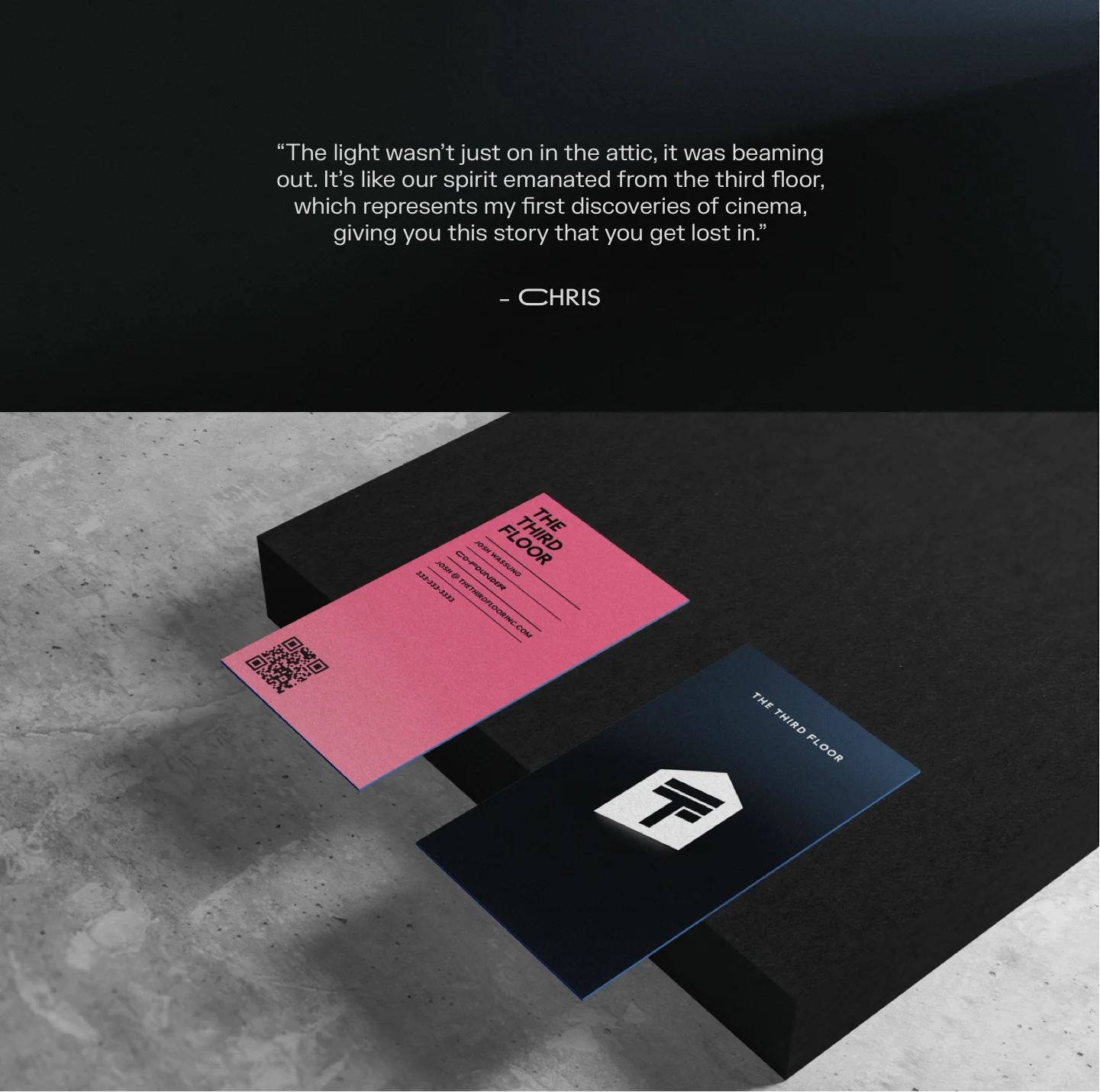 Pink and black business cards on a concrete surface with a dark background