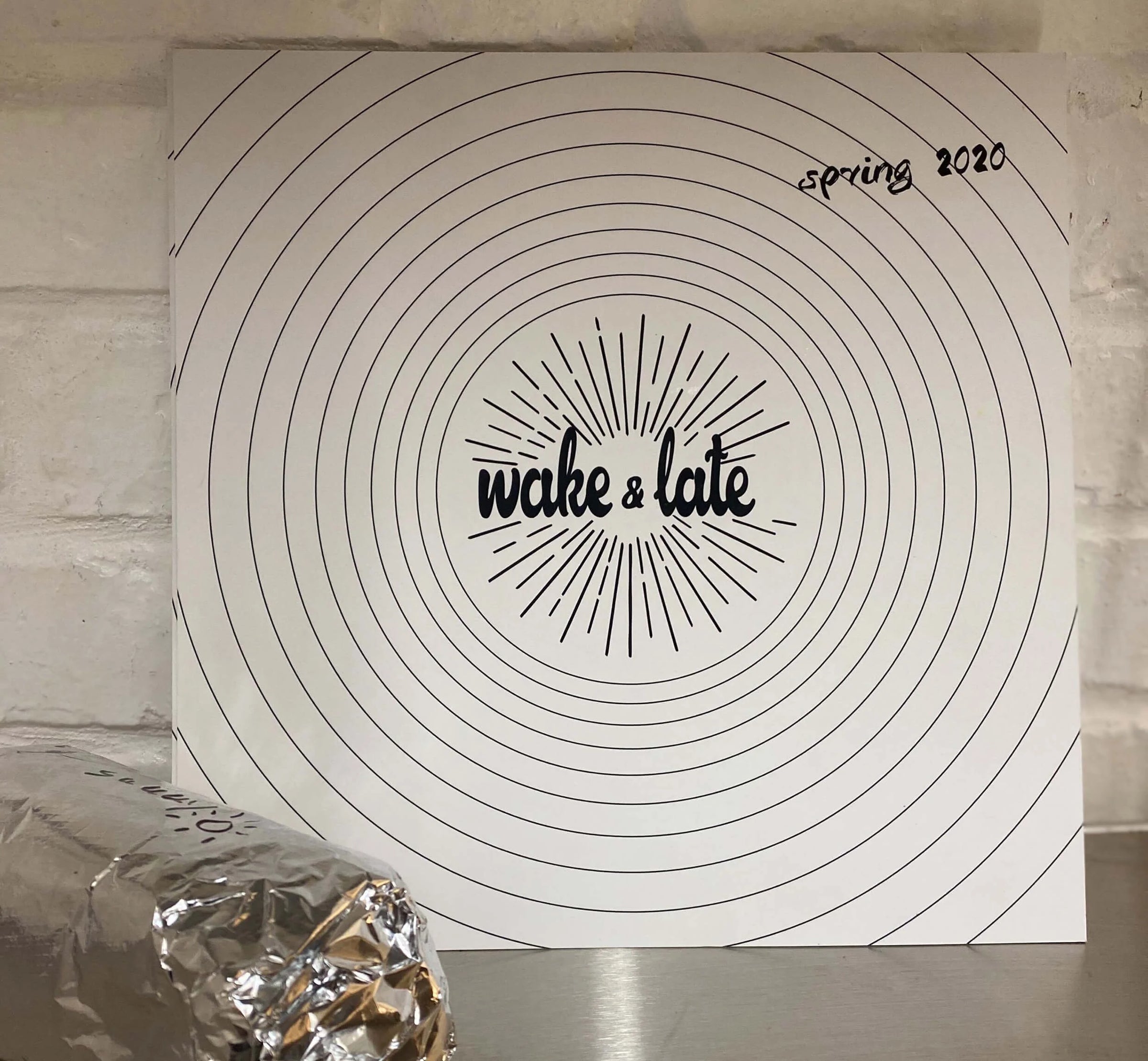 Product packaging with 'wake & late' and 'spring 2020' text on a circular design.