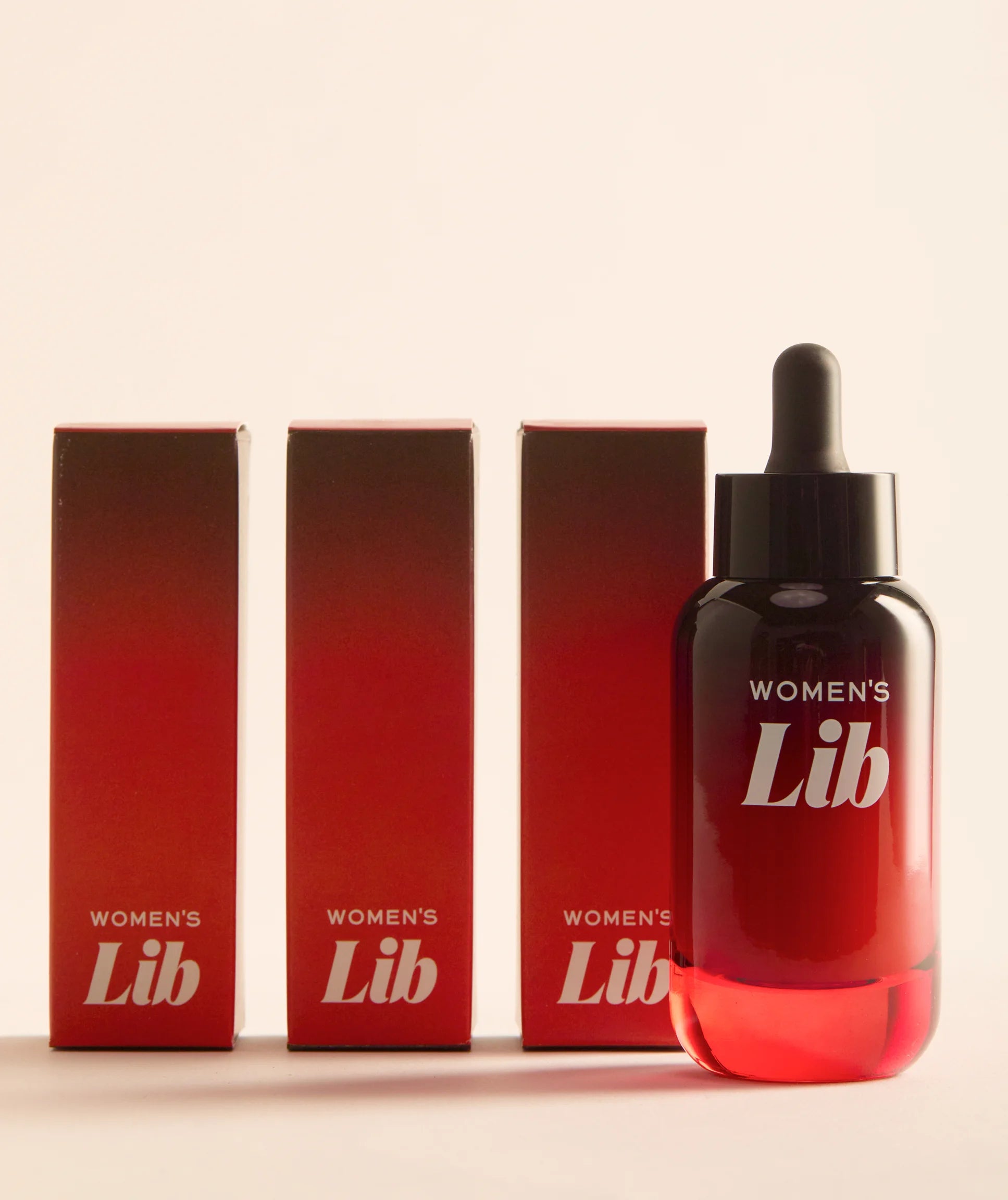 Bottle and boxes of 'Women's Lib' on a beige background