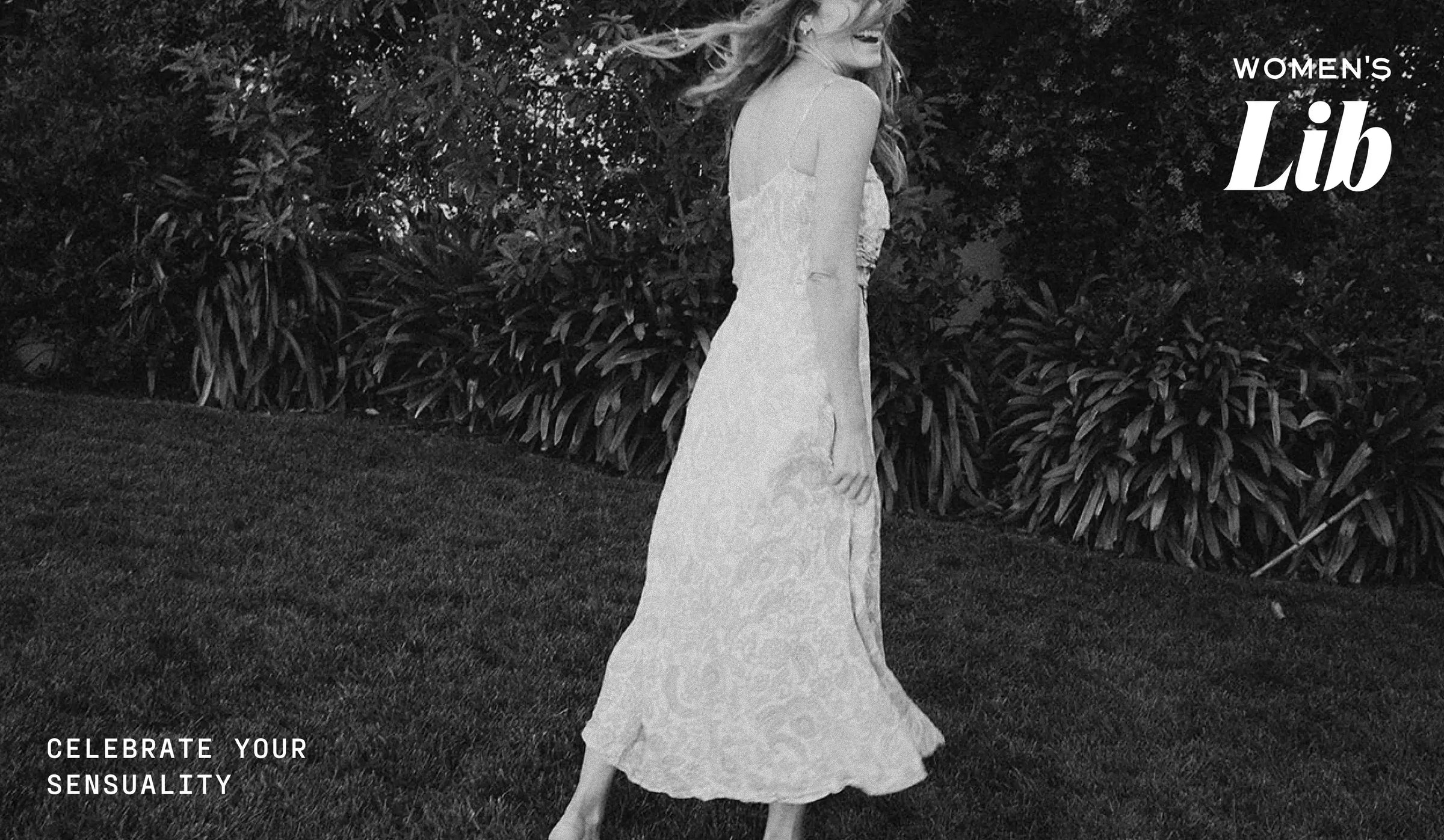 Woman in a white dress standing outdoors with 'Women's Lib' branding.